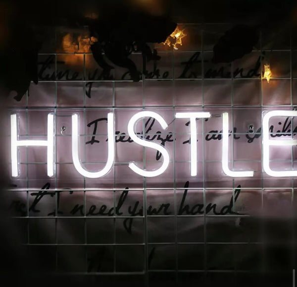 Neon white “Hustle” sign